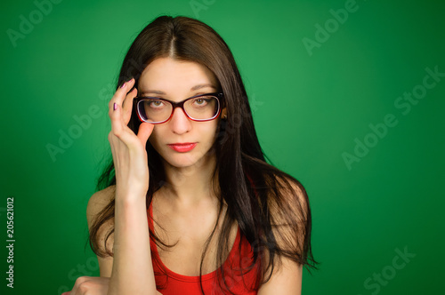 Studio Portrait Of Cute Smart Girl In Eyeglasses And Red