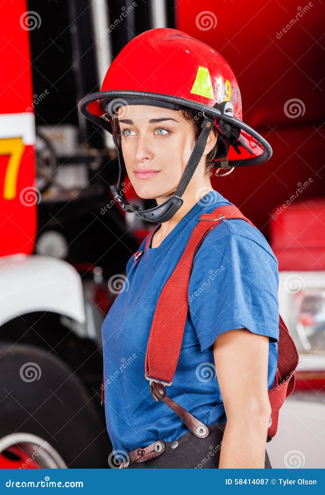 Confident Firewoman In Red Helmet Standing Against Stock Image Image