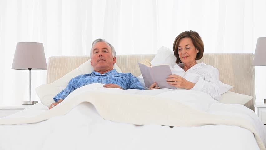 Elderly Couple Watching Tv In The Bed Stock Footage Video