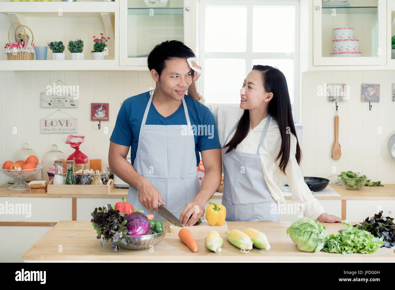 Asian Beautiful Young Wife Helping Husband Dry Sweat Off