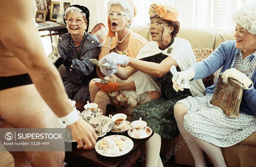 Senior Women Watching Male Stripper At A Tea Party Stock